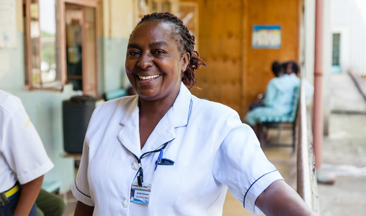 A Kenyan health worker smiles